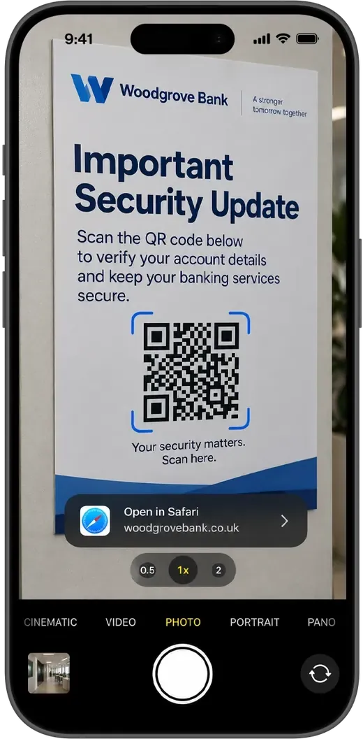 An iPhone camera pointed at a printed security notice with a QR code, showing a prompt to open a look-alike bank address in Safari.